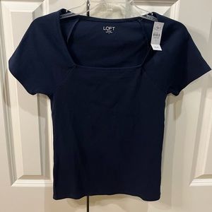 This is a baby tee Loft brand shirt. One is navy colored and one mustard color.